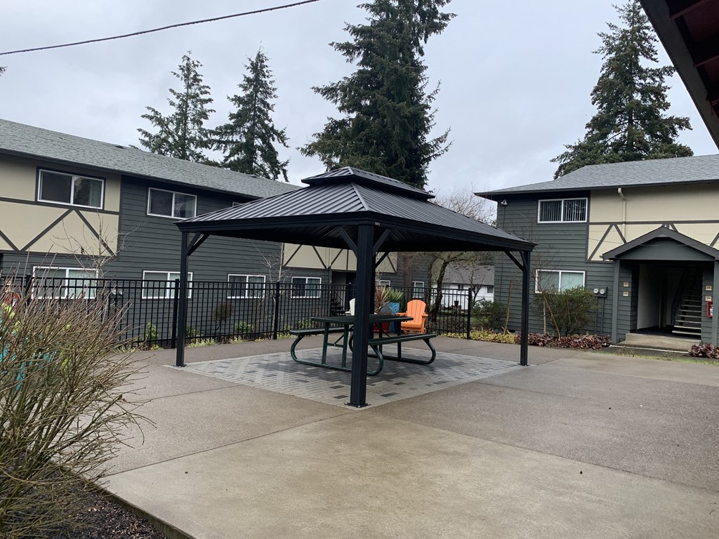 A black and white striped awning over a picnic table.