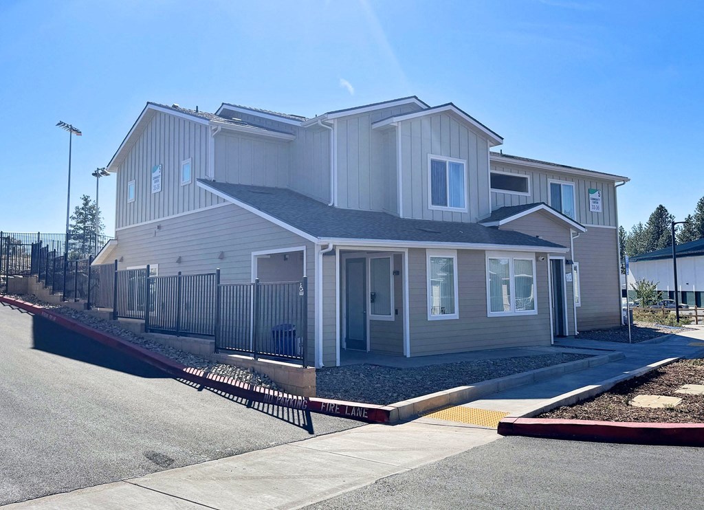 a white house with a sidewalk in front of it