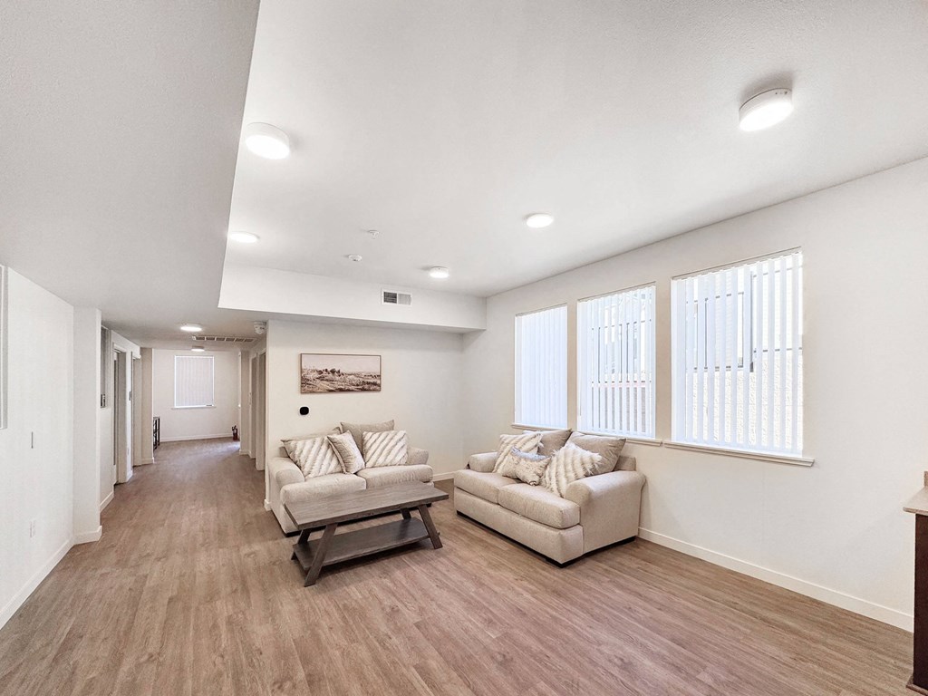 the living room of a home with two couches and a table