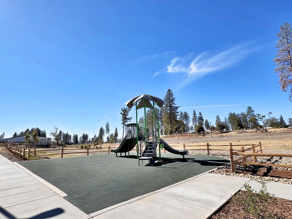 a playground with a swing set in a park