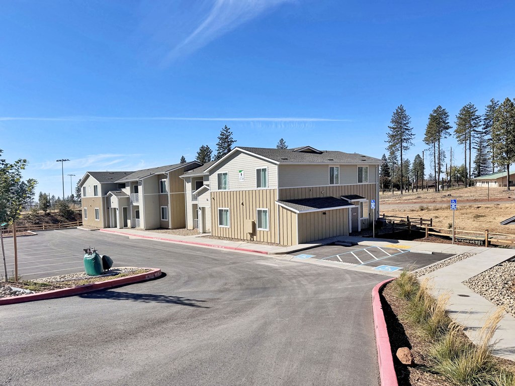 a building with a parking lot and a street in front of it