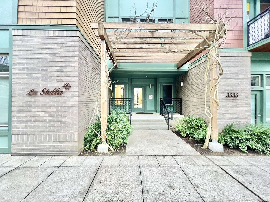 the entrance to an apartment building with awning over the sidewalk