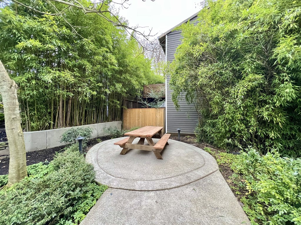 the backyard has a picnic table in the middle of a circle