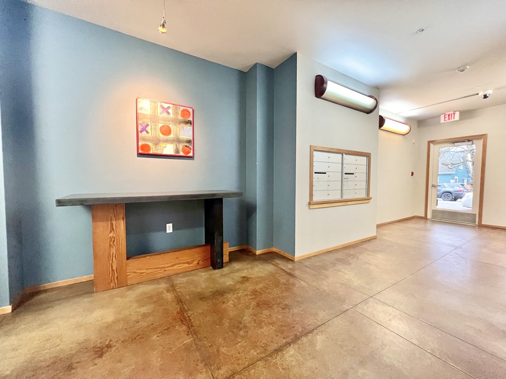 a room with a fireplace and a blue wall and a door