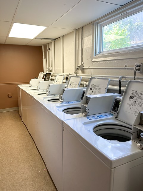 A row of washing machines in a laundromat.