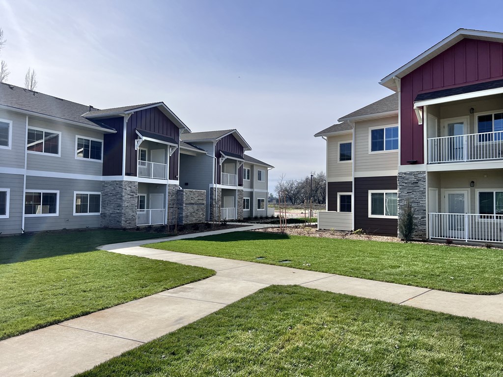 A row of houses with a walkway in between.