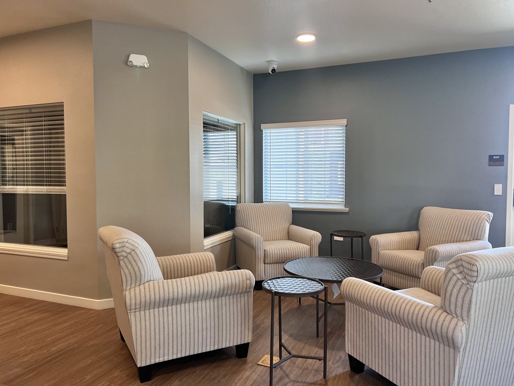 A living room with striped chairs and a table.