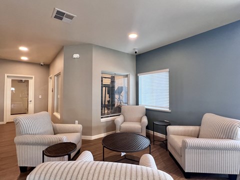 A living room with striped couches and a round table.