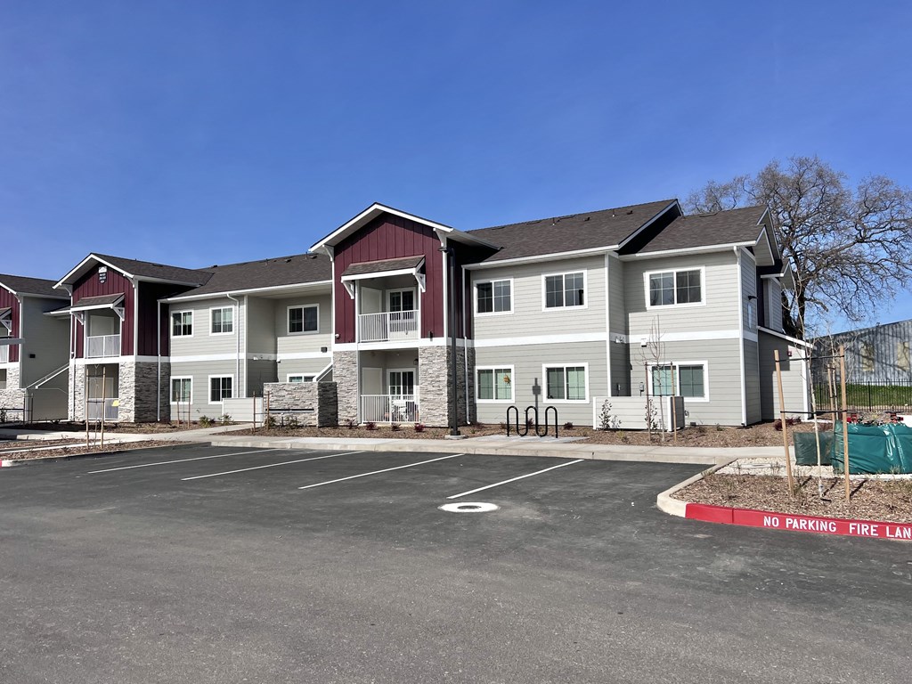 A large building with a parking lot in front of it that says no parking.