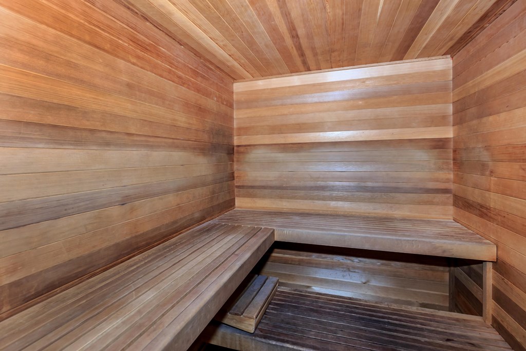 a wooden sauna with wooden walls and a bench