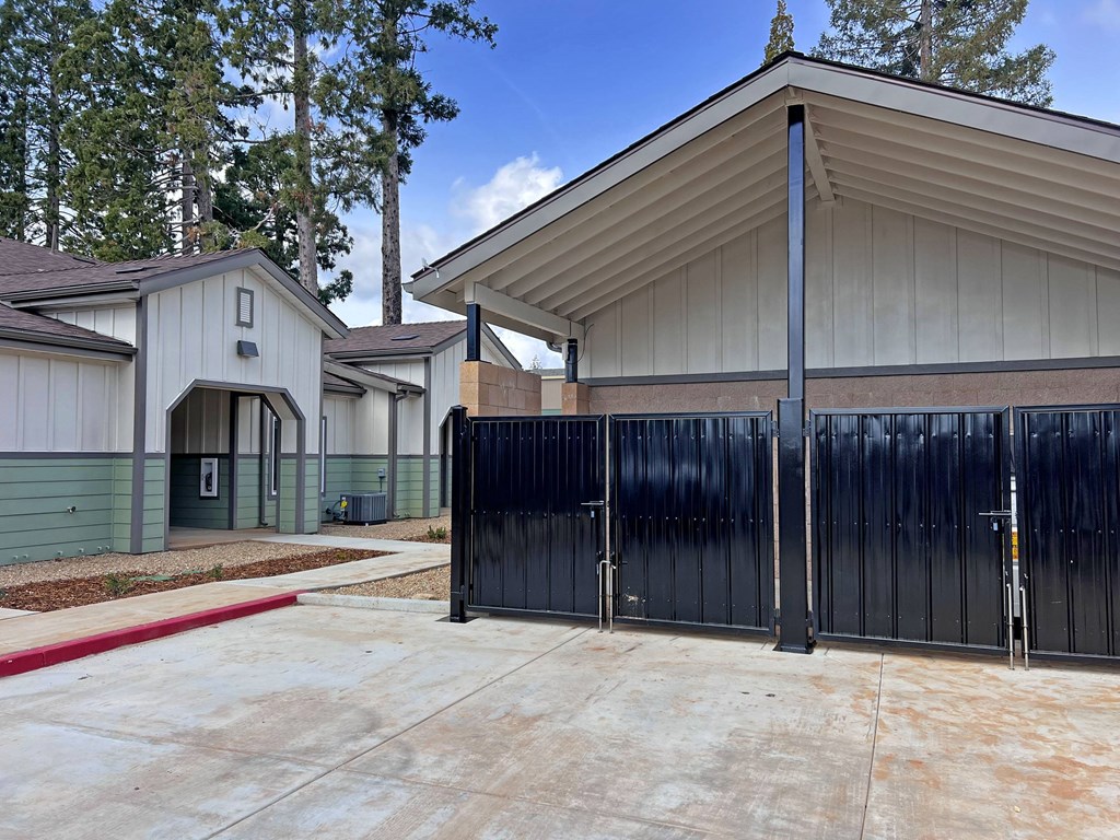 A black gate is in front of a building.