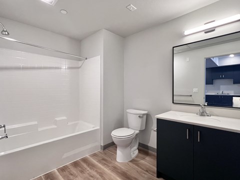 A white toilet sits next to a white sink in a bathroom.