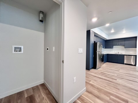 A kitchen with a refrigerator, cabinets, and a countertop.