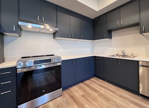 A modern kitchen with a stove and cabinets.