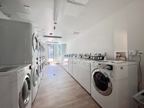 A row of washing machines in a laundromat.