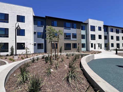 A modern building with a pool in front.