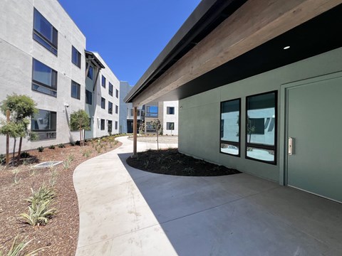 A modern building with a concrete walkway in front.