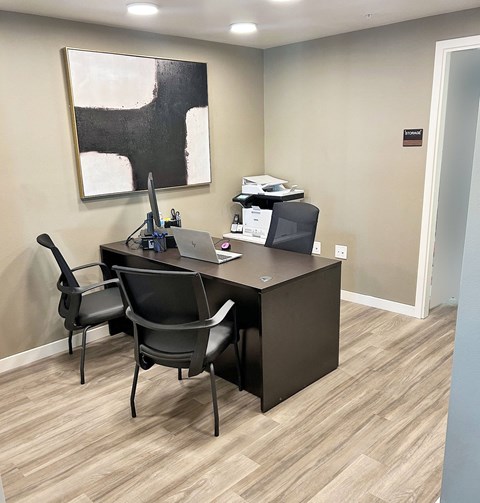 an office with a desk and a computer