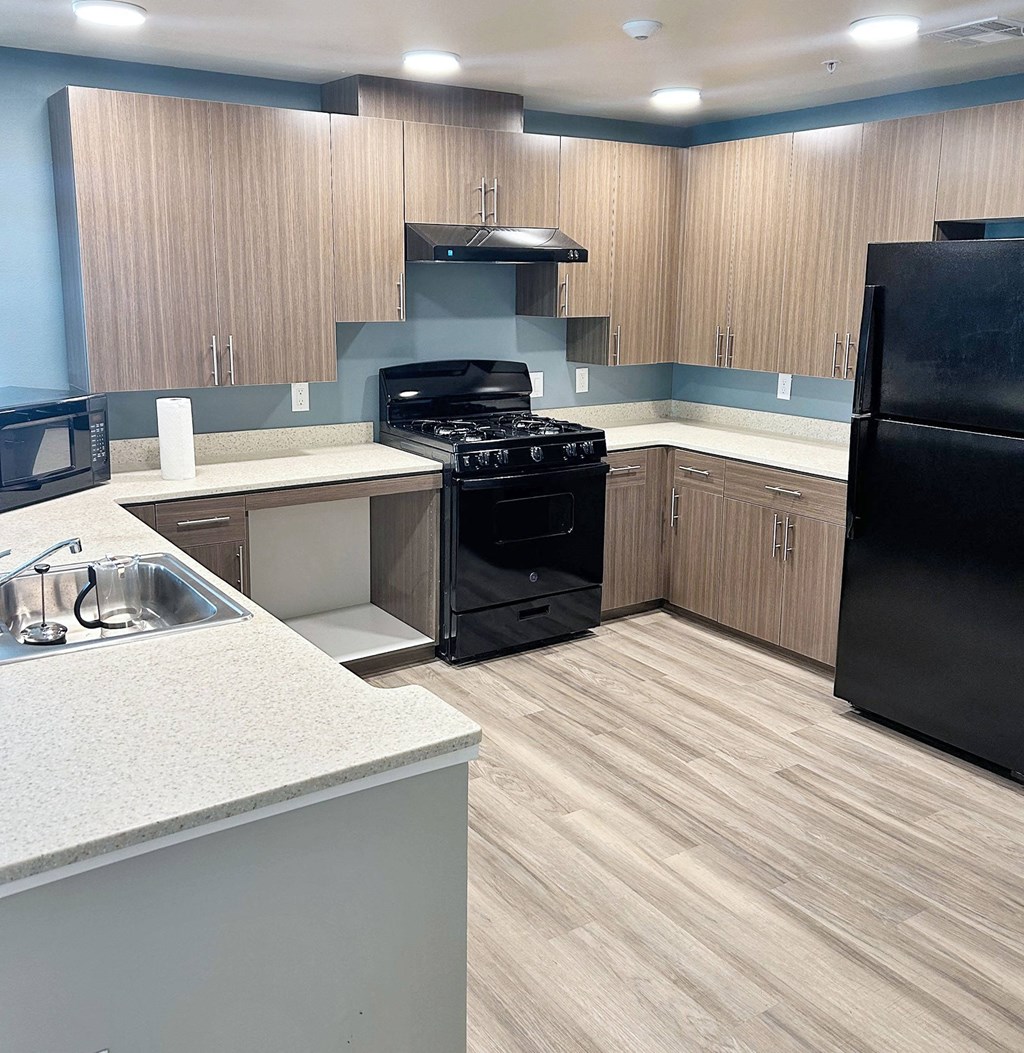a kitchen with black appliances and wooden cabinets