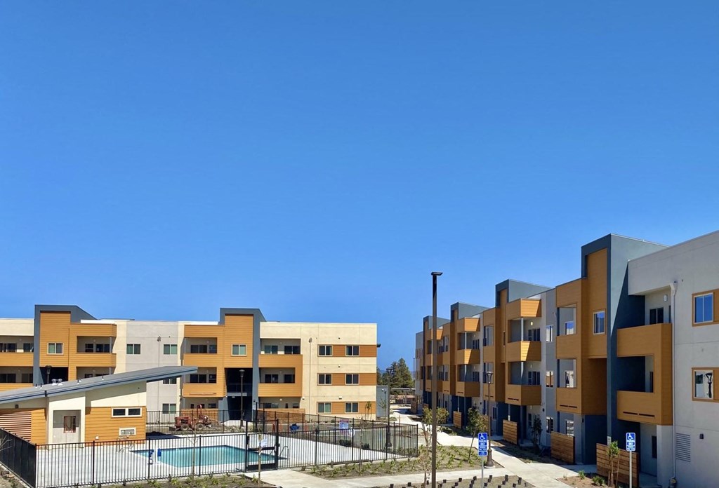 Willow View wide angle view of property with pool and bright blue sky