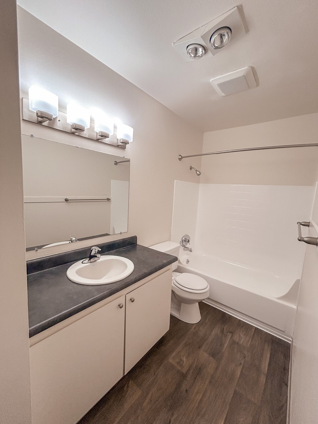 A bathroom with a sink, toilet, and bathtub.