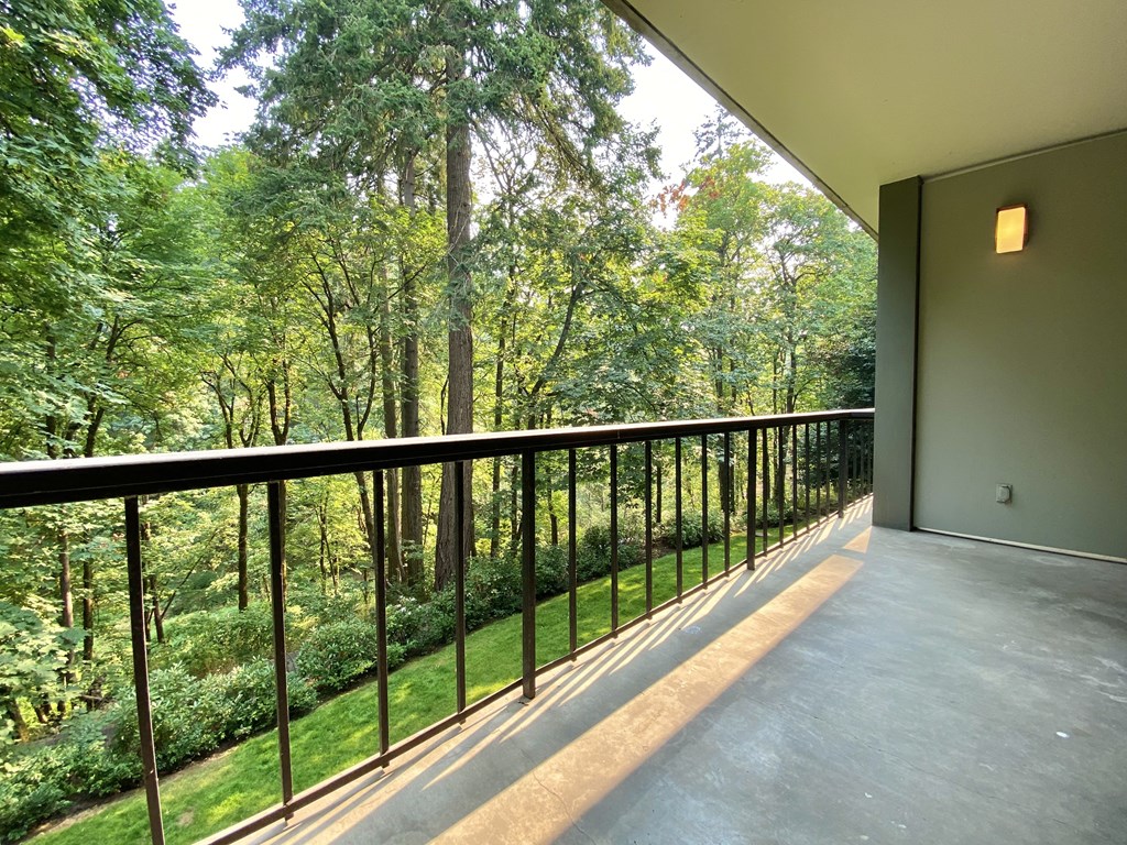 a balcony with a view of a forest