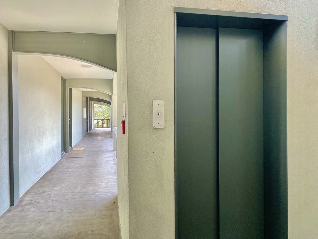 an empty hallway with an open door to a room