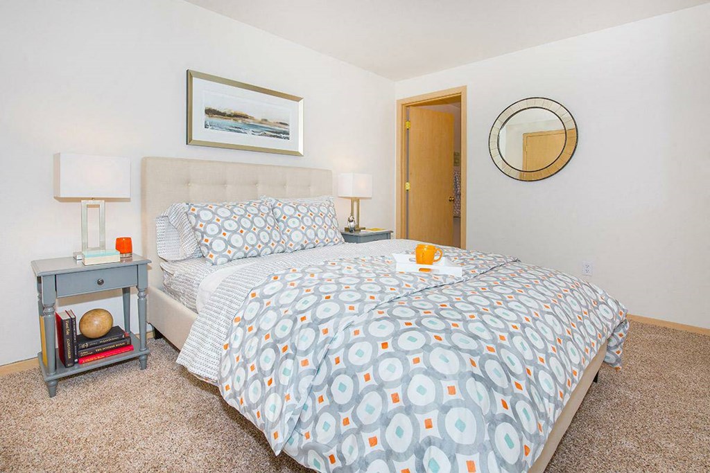 a bedroom with a bed and a mirror