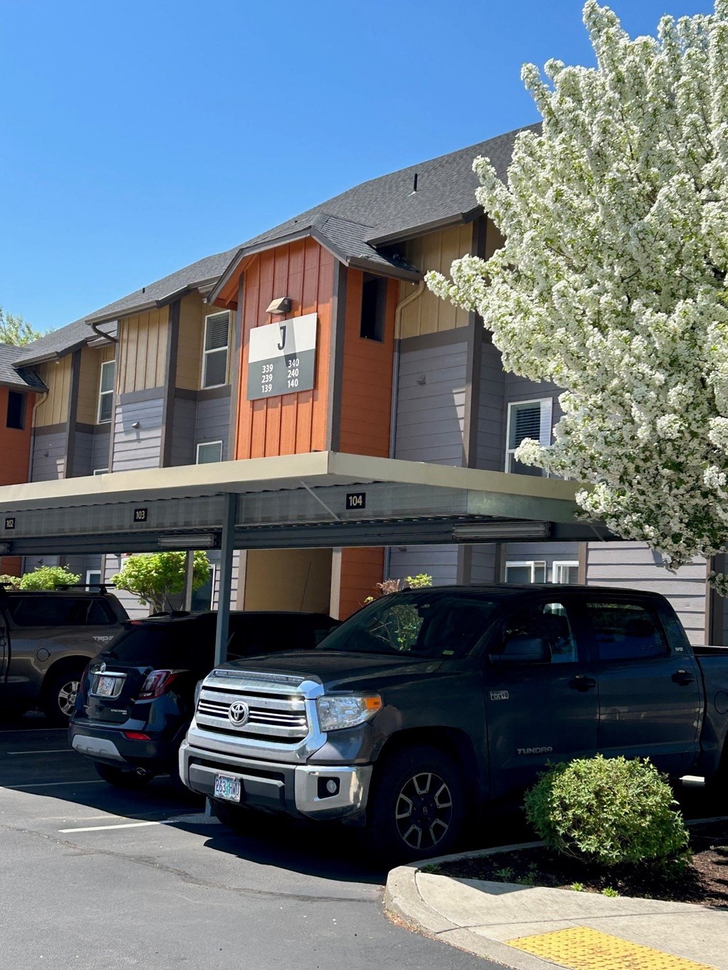 a building with a parking lot and a truck parked in front of it