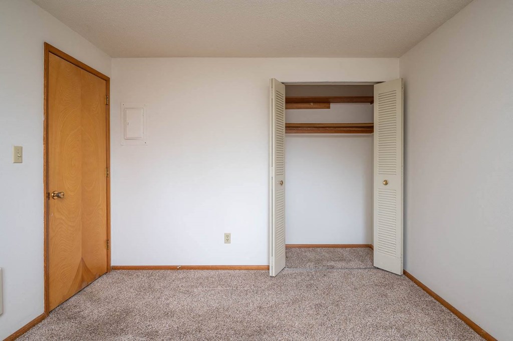 a bedroom with a closet and an open door
