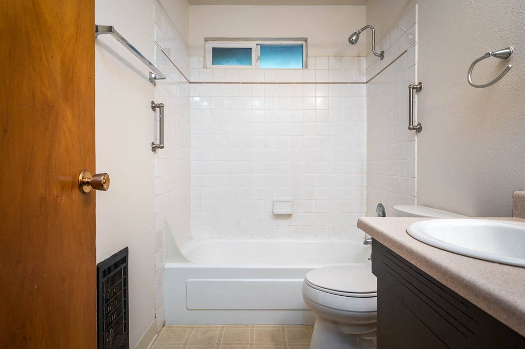 a bathroom with a toilet sink and bathtub