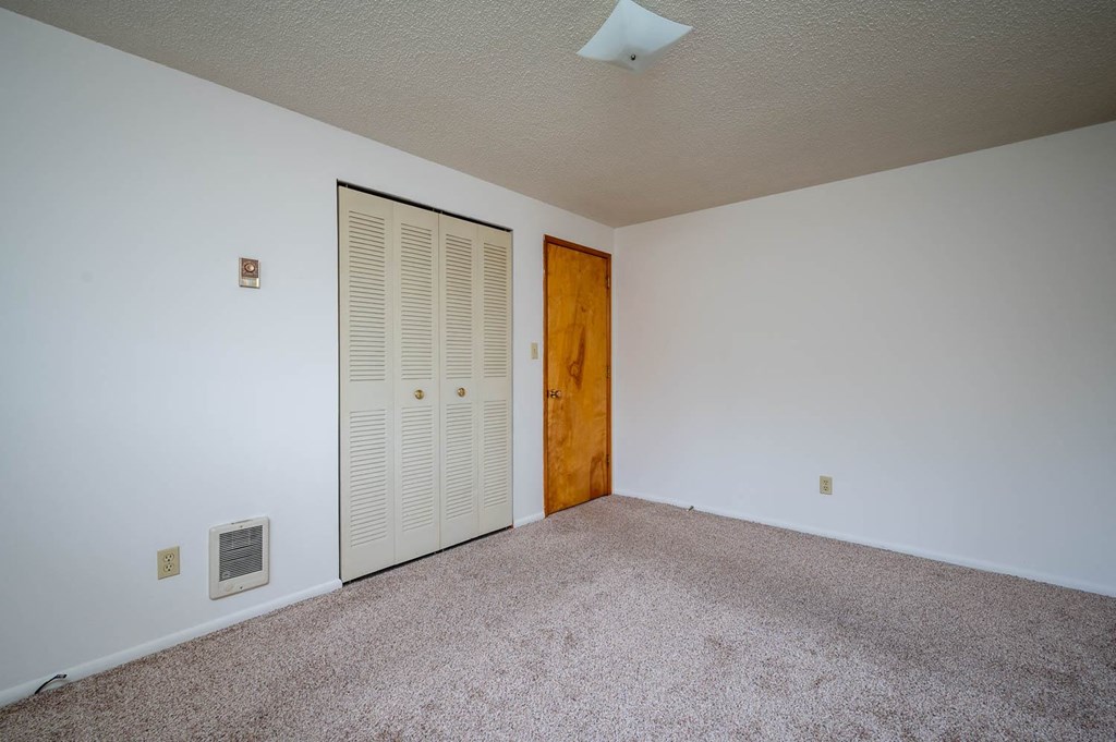 a bedroom with a closet and a door