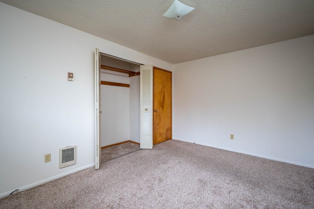 a bedroom with a closet and an open door