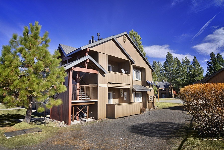 an image of the back of a house with a blue sky in the background