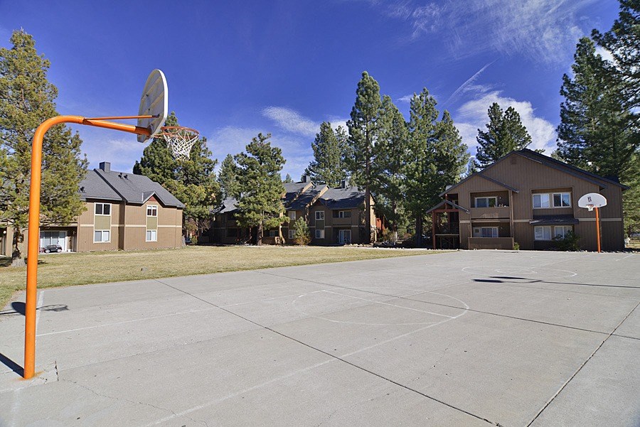 a basketball court in front of a house