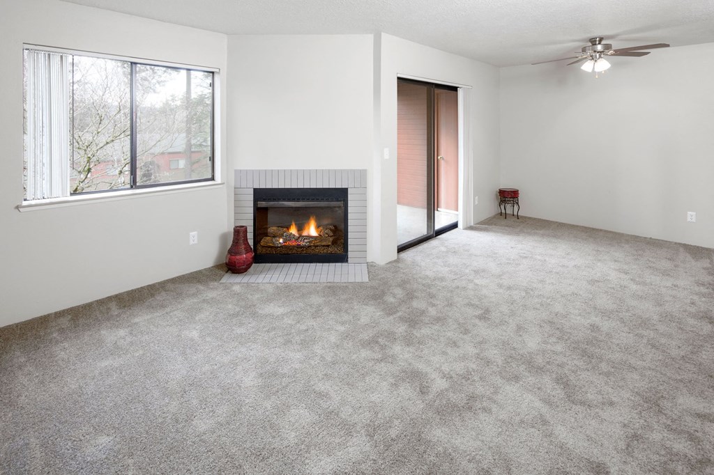 an empty living room with a fireplace