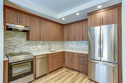 a kitchen with stainless steel appliances and wooden cabinets