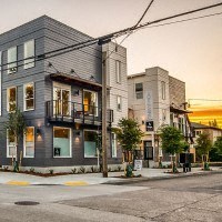 a city street with tall buildings on the corner