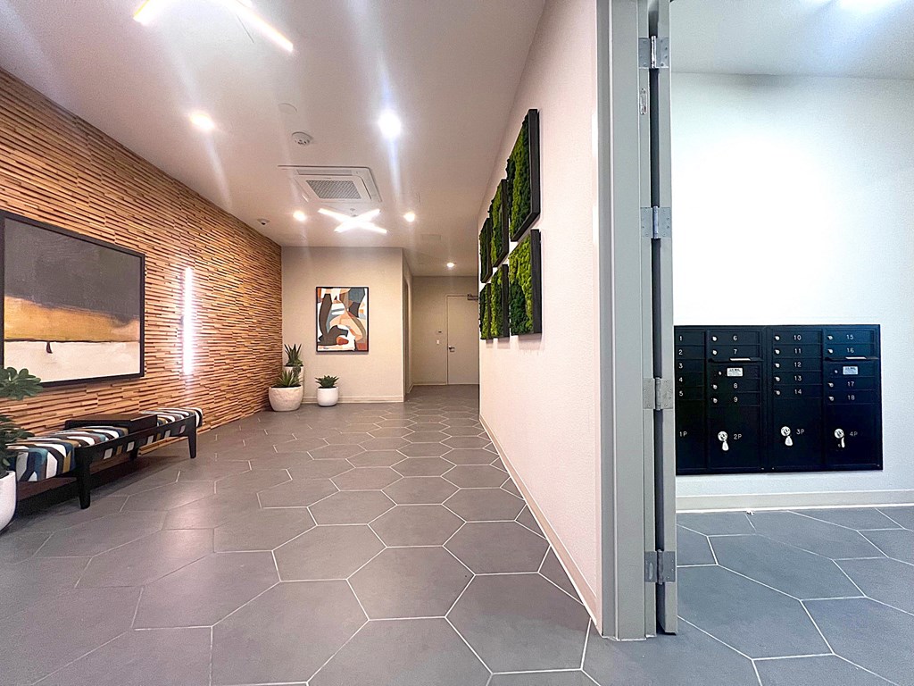 a hallway with a door to a room with a painting on the wall