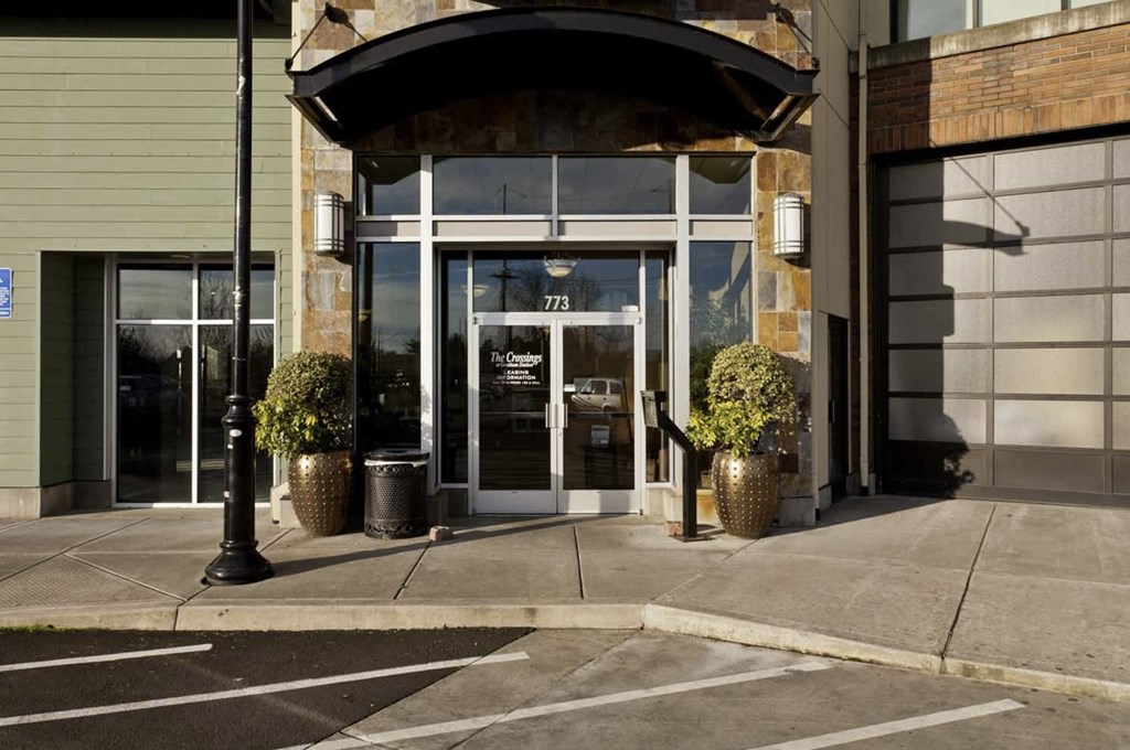 A building with a large glass door and a sign that reads 777 on it.