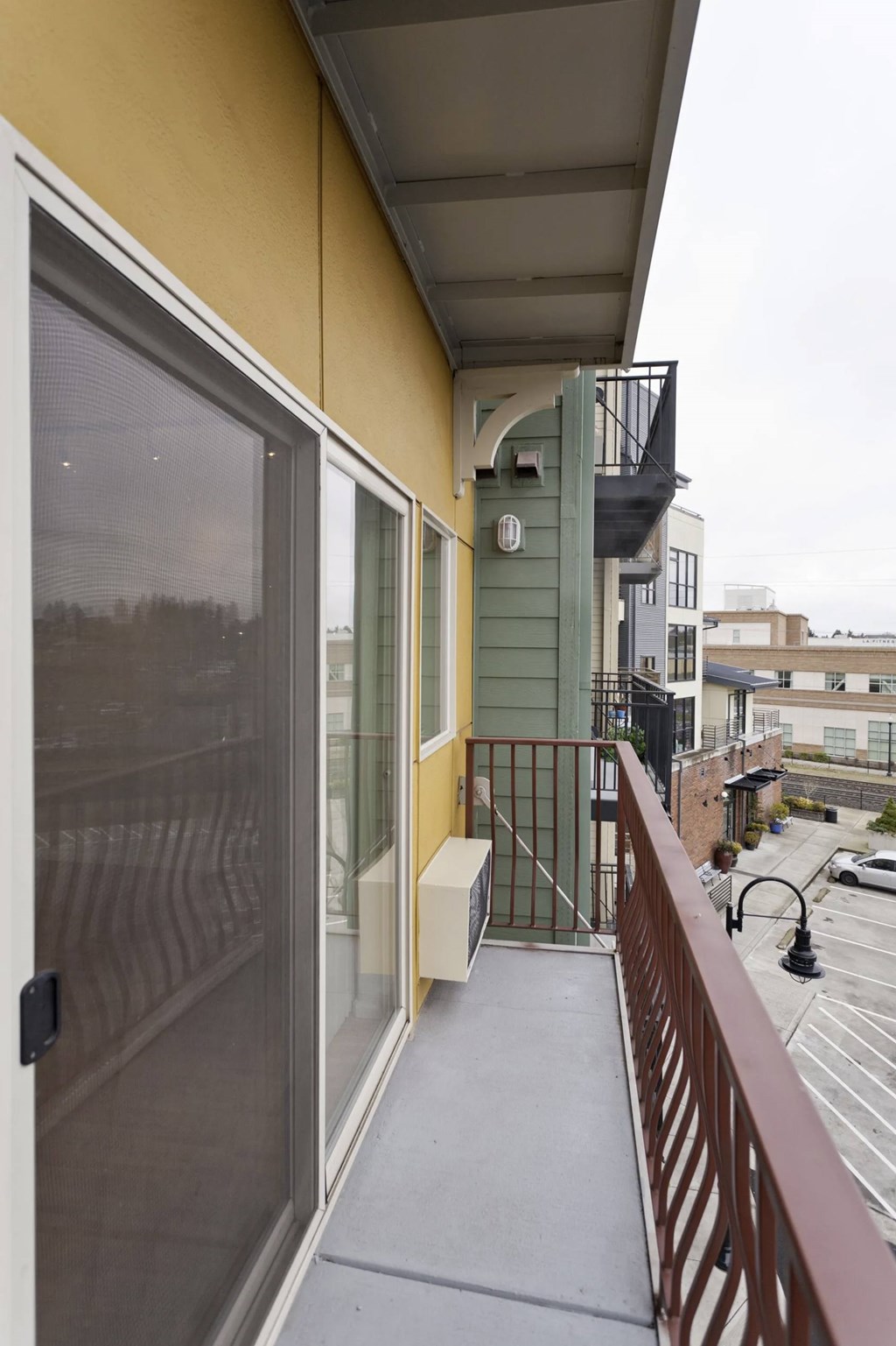 A balcony with a metal railing and a glass door.