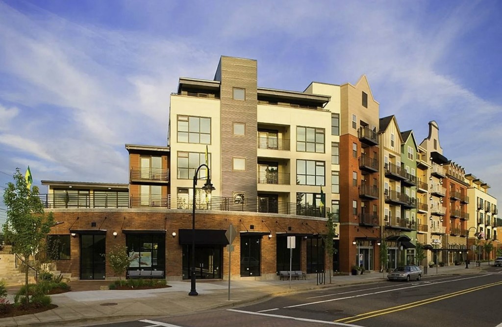 A street view of a row of modern buildings.