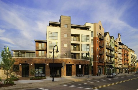 A street view of a row of modern buildings.