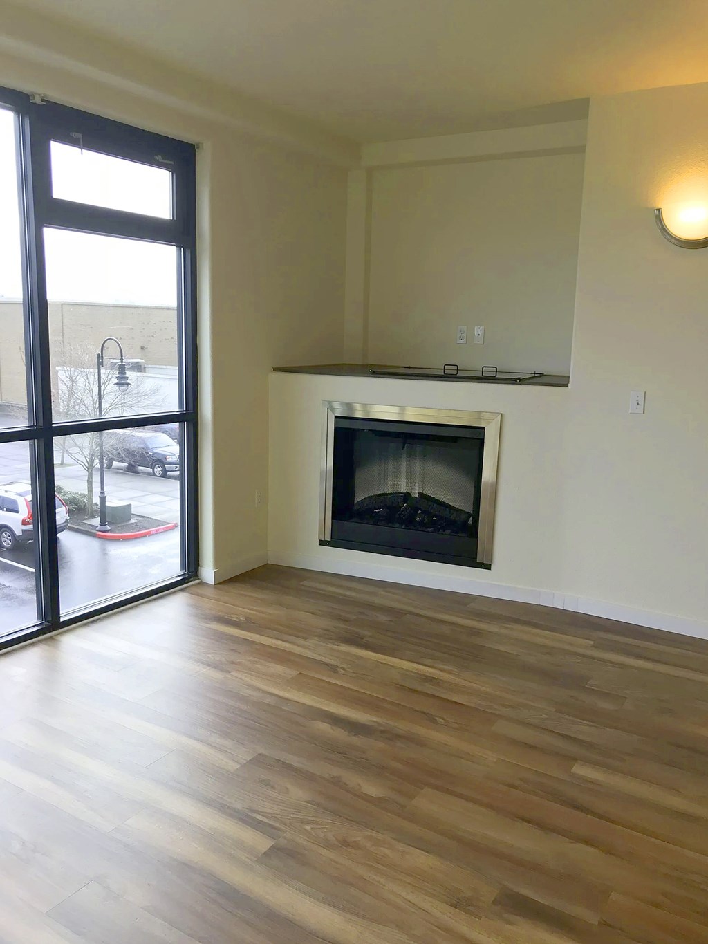 A room with a fireplace and sliding glass doors.