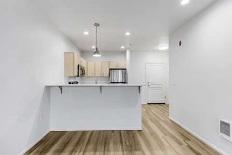A kitchen with white cabinets and a white island.