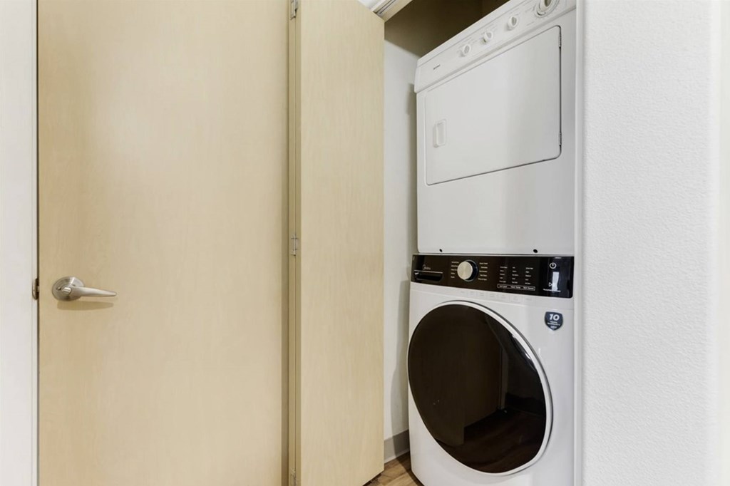 A white dryer is in a small room.