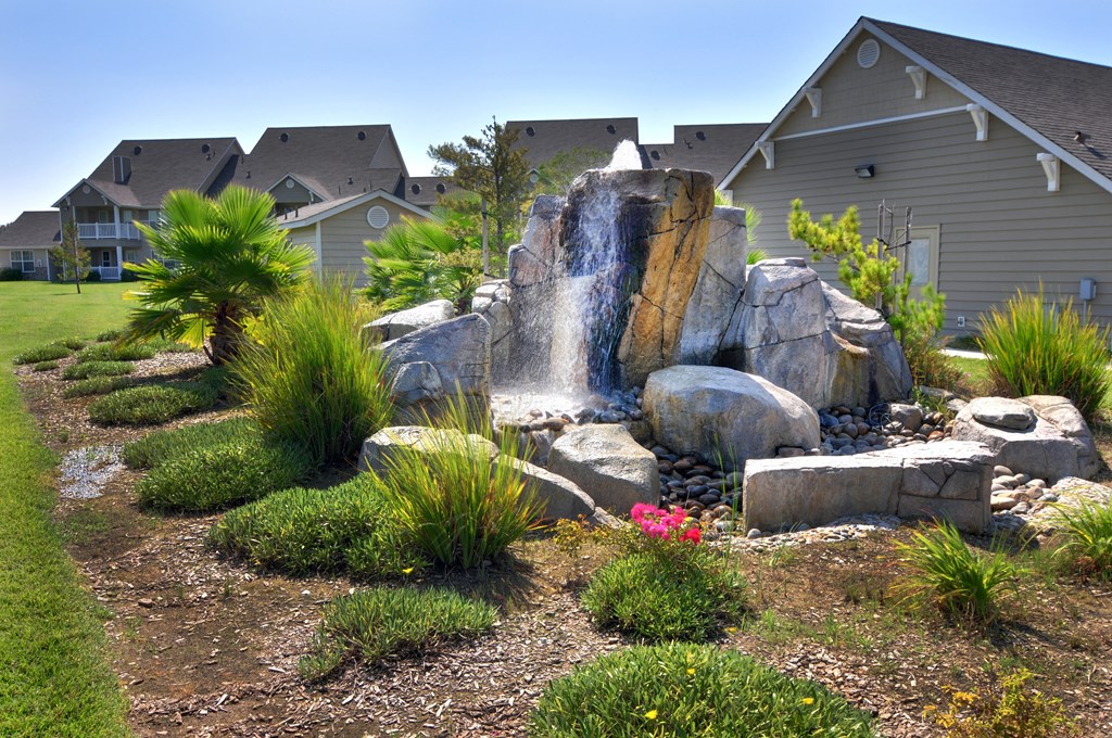 a waterfall in the front yard of a home