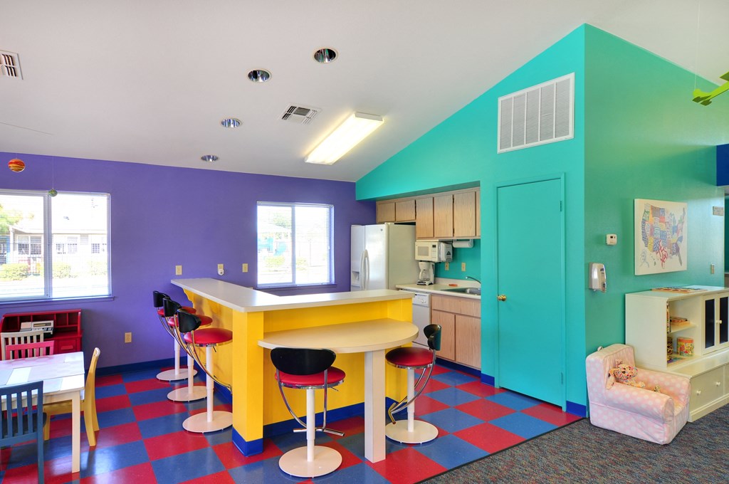a kitchen and dining area with a colorful checkered floor