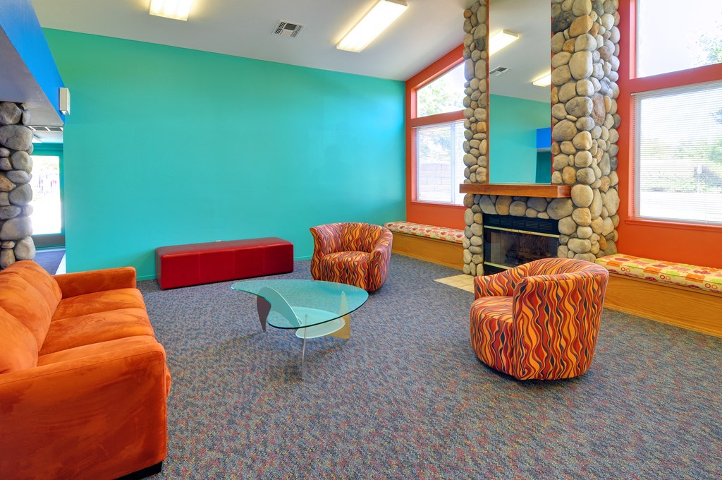 a living room with orange furniture and a blue wall