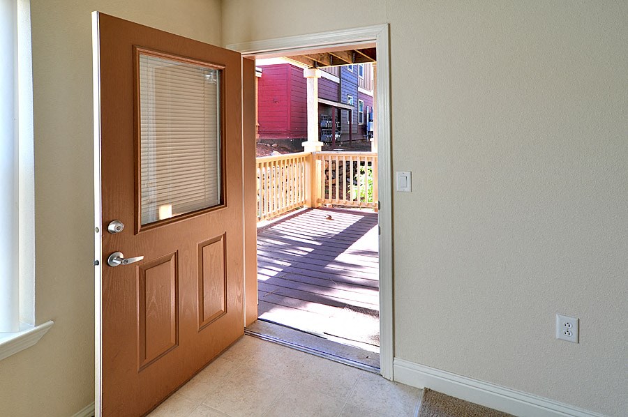 an open door leading to a wooden deck